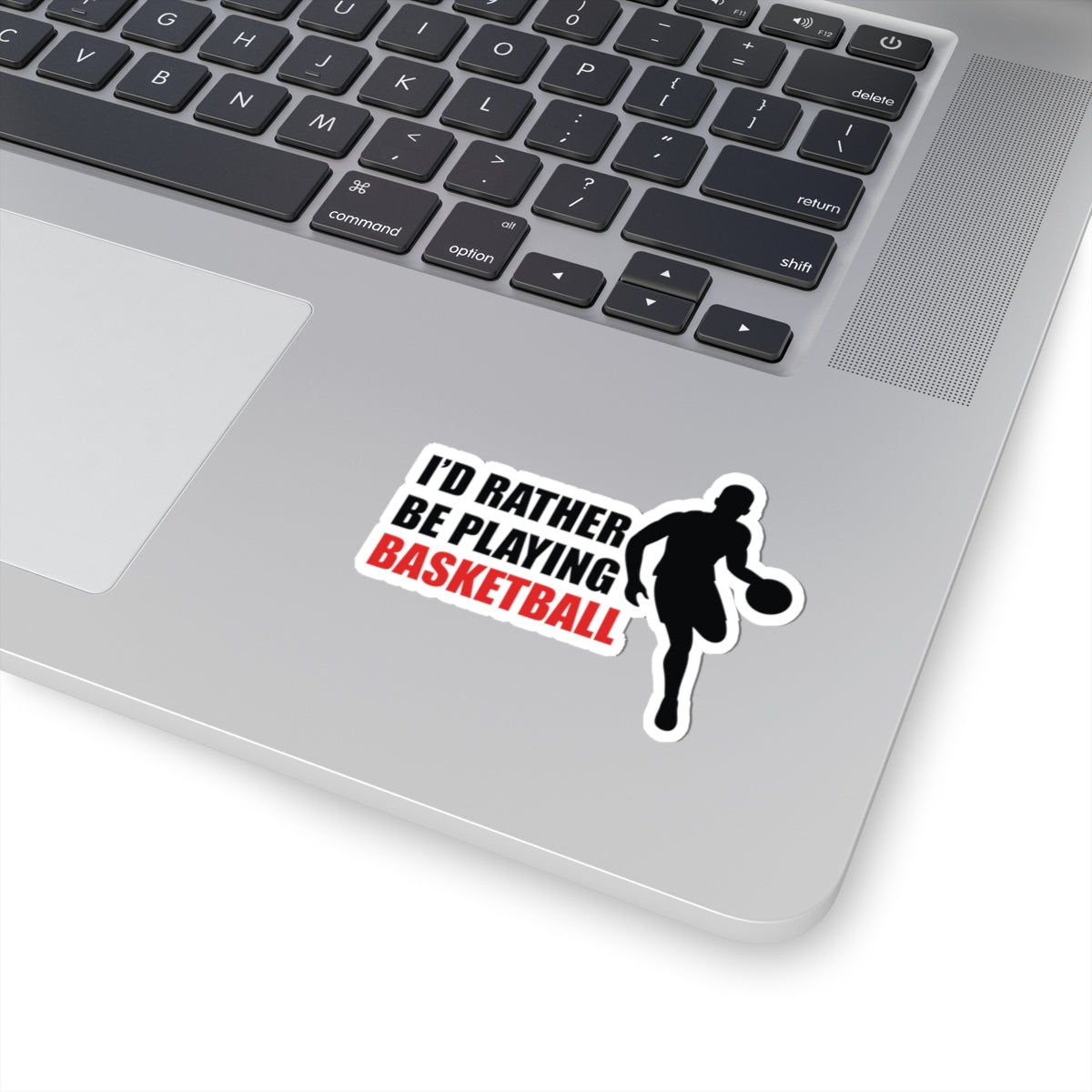Kiss Sticker - Basketball with a dribbling player silhouette and bold text on a silver laptop surface
