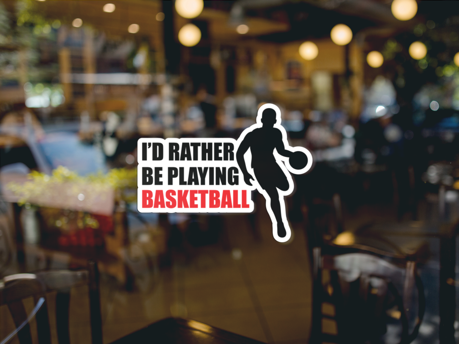 Kiss Sticker - Basketball with a silhouette of a player and bold text "I'd rather be playing BASKETBALL" on glass window surface