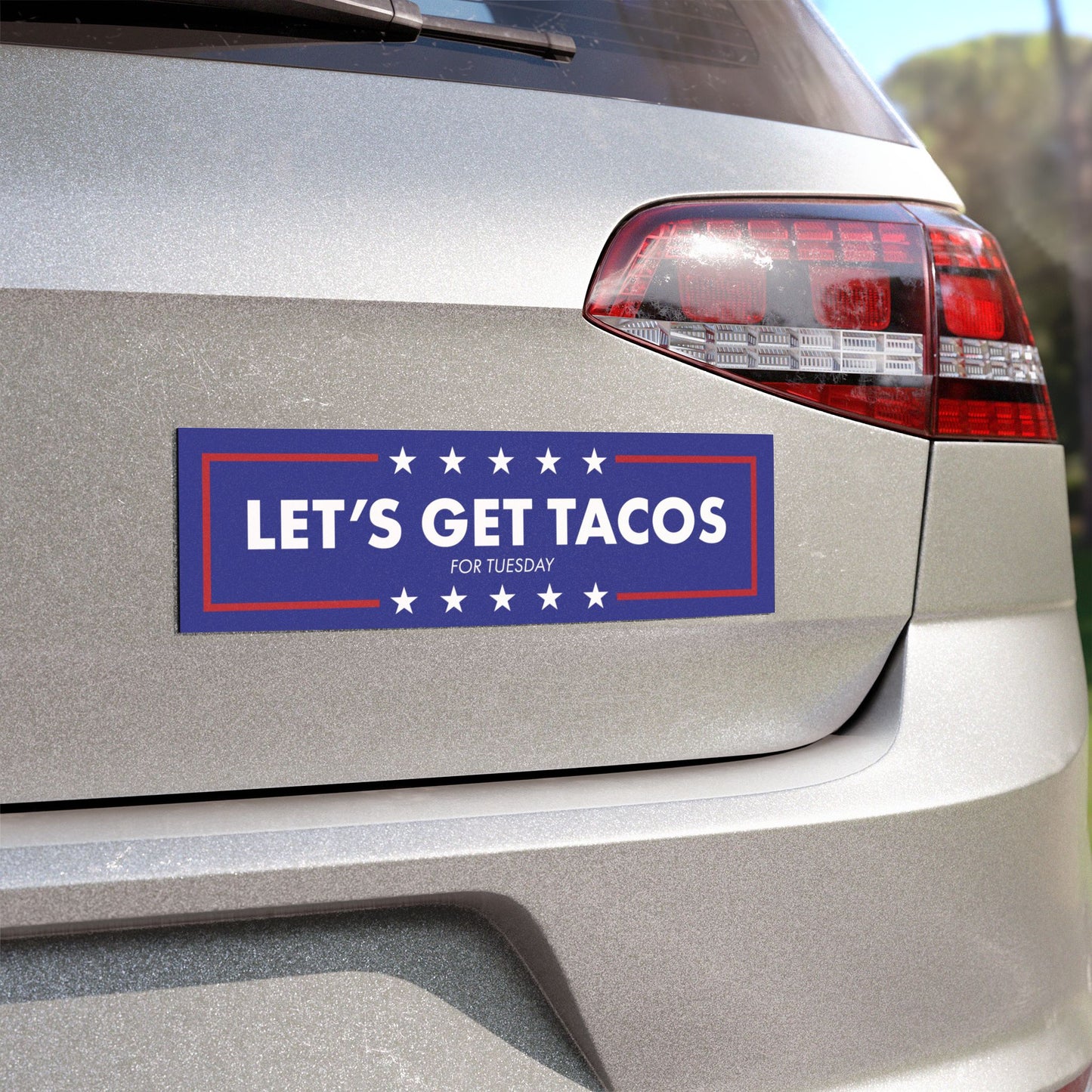 Political Humor Car Magnet - Let's Get Tacos featuring bold white text and stars on blue background displayed on a car bumper